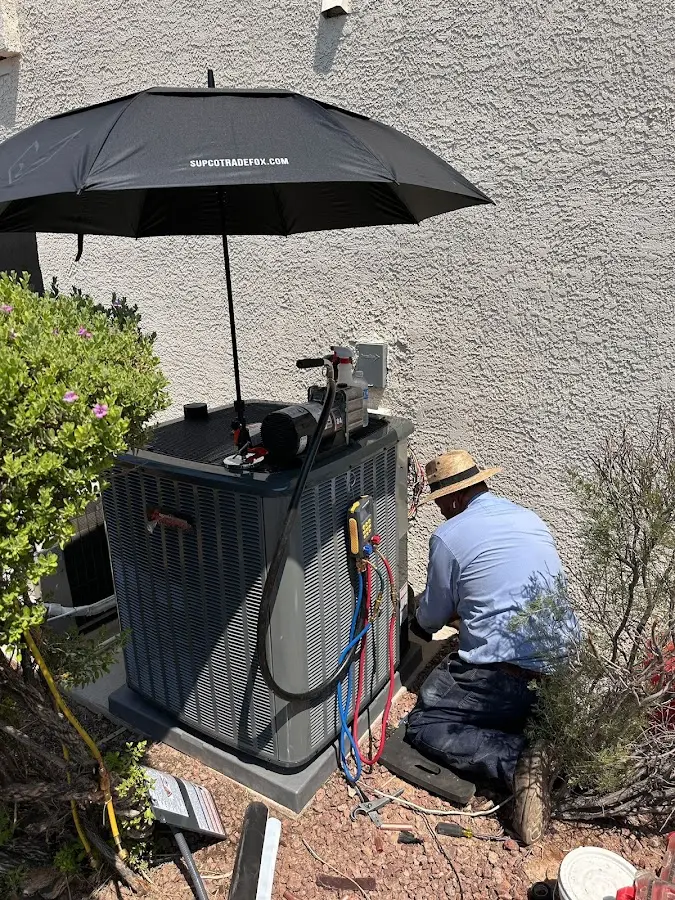 HVAC technician performing outdoor AC maintenance in Forney